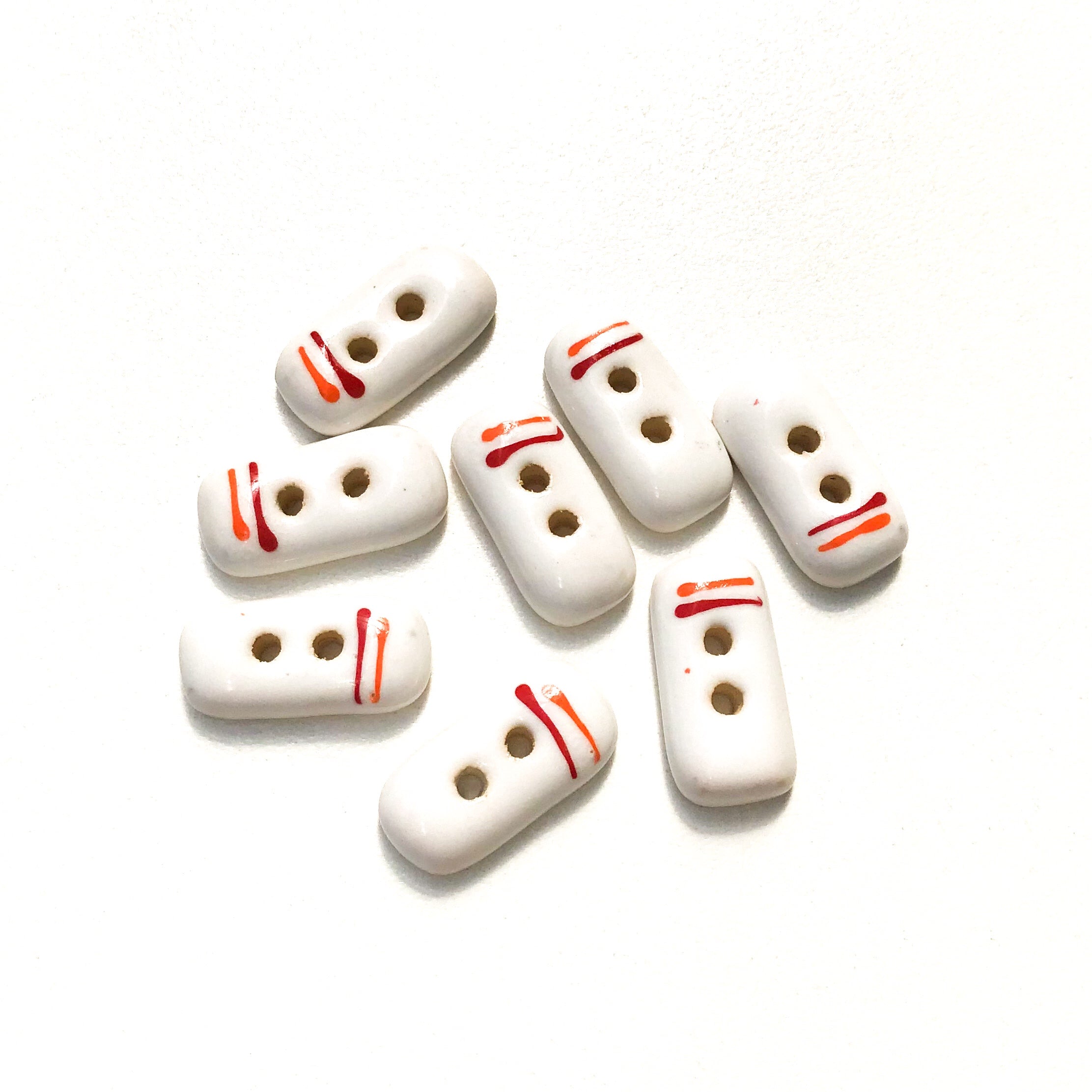 order-your-favorite-rectangular-white-ceramic-buttons-with-orange-red-lines-white-clay-buttons-3-8-x-3-4-8-pack-discount_0.jpg