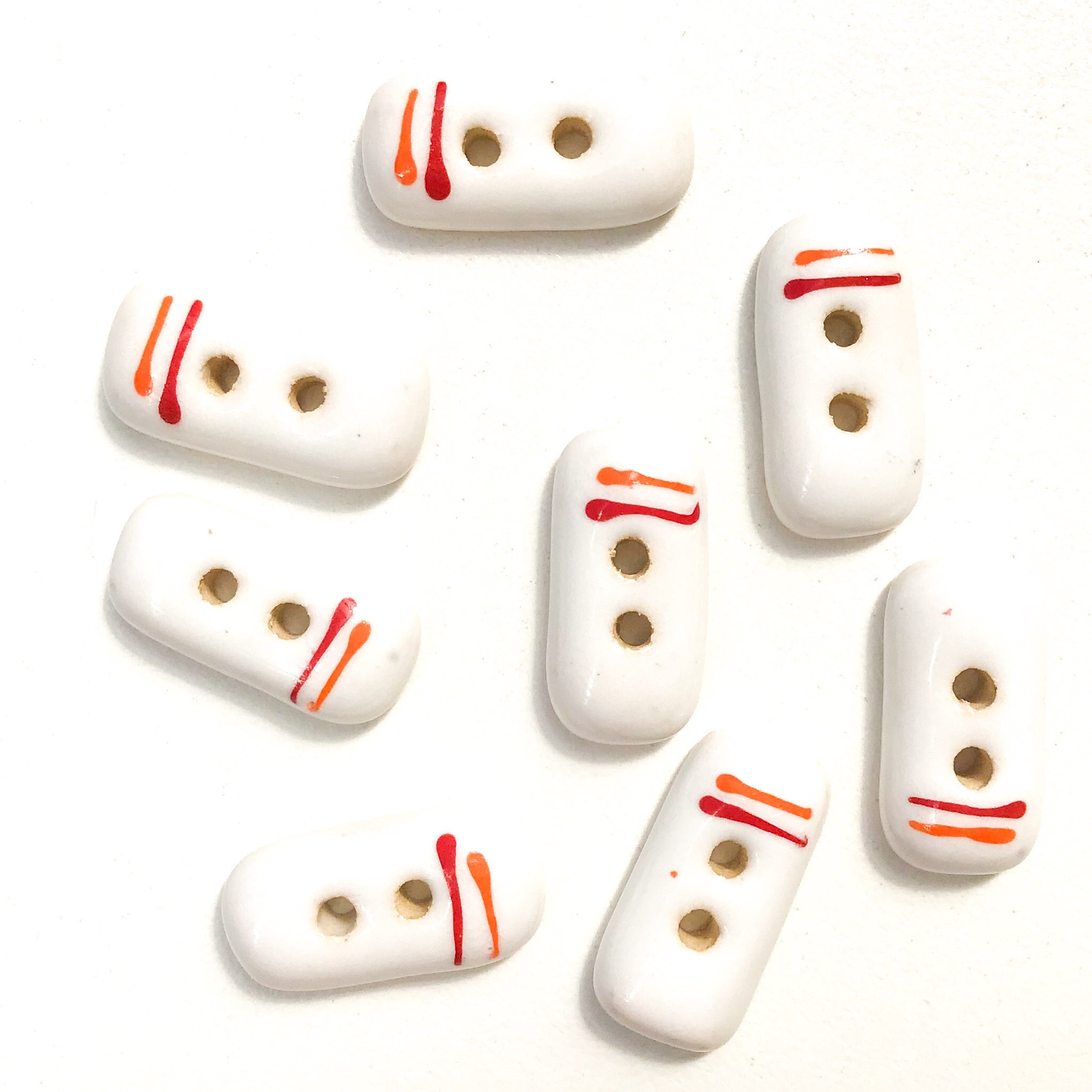 order-your-favorite-rectangular-white-ceramic-buttons-with-orange-red-lines-white-clay-buttons-3-8-x-3-4-8-pack-discount_1.jpg